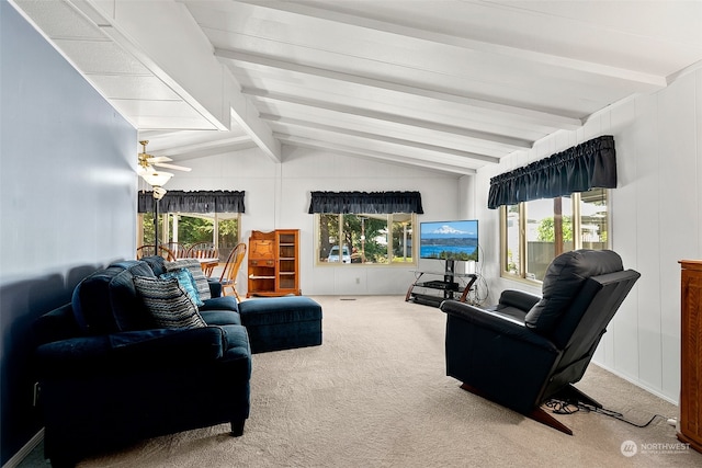 carpeted living room with ceiling fan, a healthy amount of sunlight, and lofted ceiling with beams