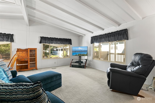 living room with lofted ceiling with beams, carpet flooring, and a wealth of natural light