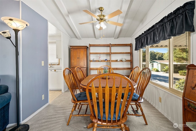 dining area with lofted ceiling with beams, light colored carpet, and ceiling fan