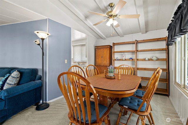 carpeted dining area featuring lofted ceiling with beams and ceiling fan