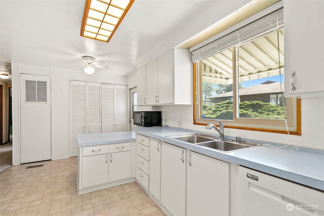 kitchen featuring kitchen peninsula, white dishwasher, sink, white cabinets, and ceiling fan