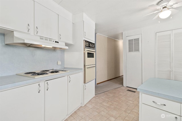 kitchen featuring under cabinet range hood, white appliances, light countertops, and a ceiling fan