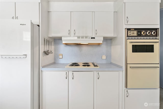 kitchen with white cabinetry, backsplash, and white appliances