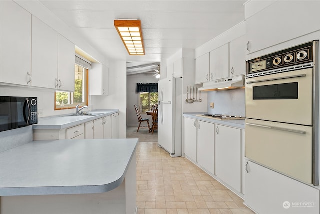 kitchen with white cabinetry, ceiling fan, sink, and white appliances