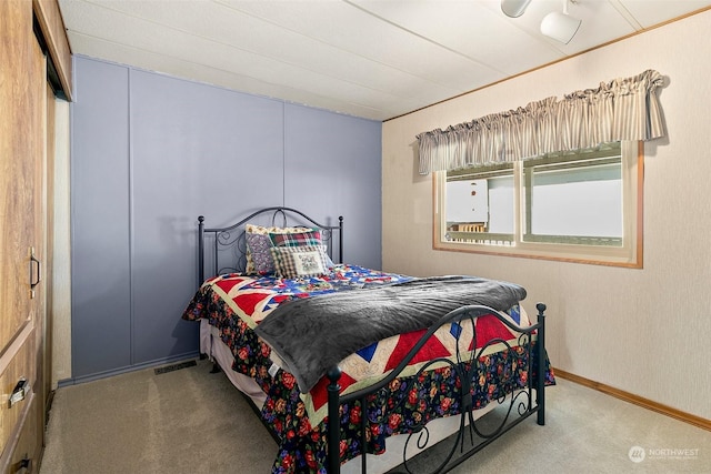 bedroom with carpet flooring and baseboards