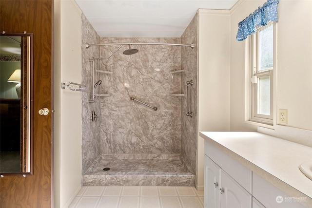 bathroom featuring a tile shower, plenty of natural light, and vanity