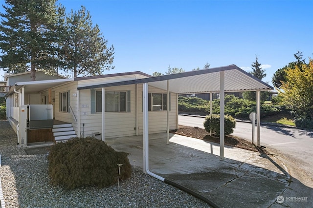 view of side of home with an attached carport