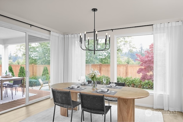 dining room with a notable chandelier and light hardwood / wood-style flooring