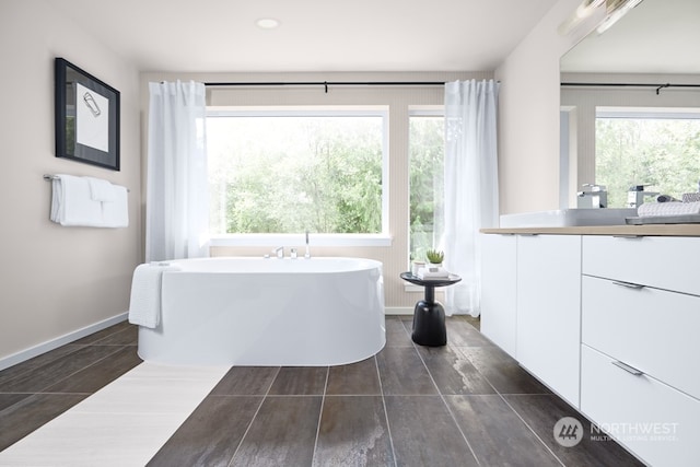 bathroom featuring vanity and a tub