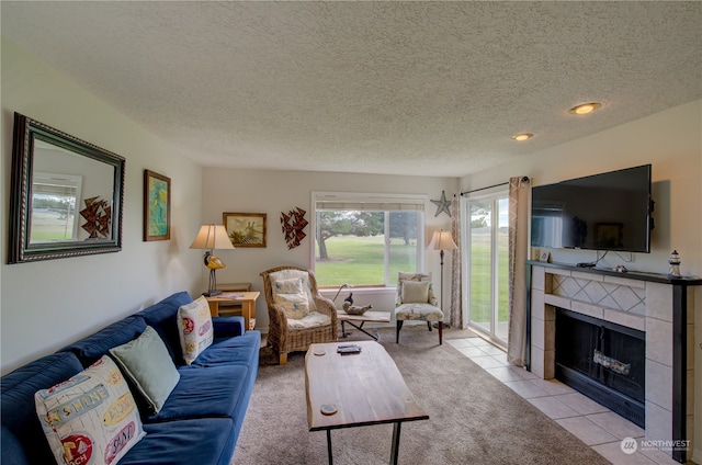 tiled living room featuring a fireplace and a textured ceiling