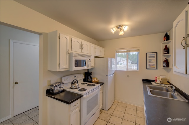 kitchen with white appliances, white cabinets, sink, and light tile patterned floors