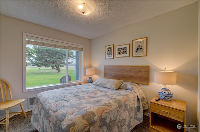 carpeted bedroom with a textured ceiling