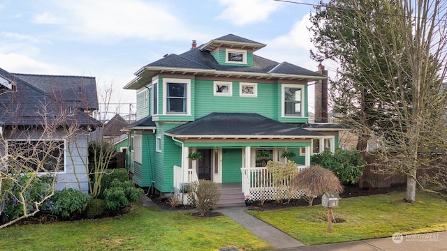 view of front of house with a porch and a front lawn