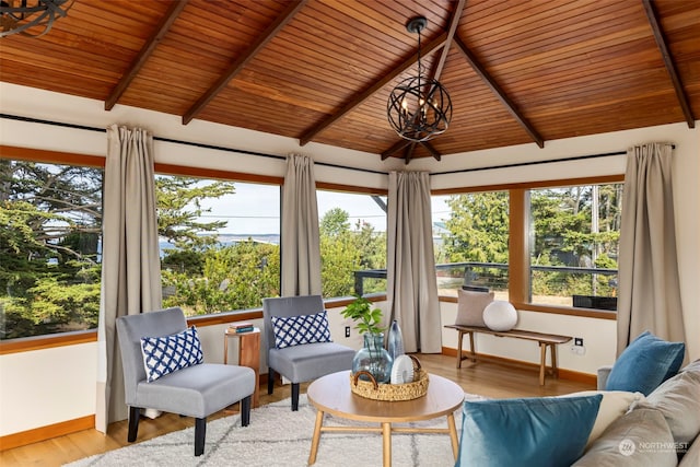 sunroom featuring wooden ceiling, lofted ceiling with beams, and an inviting chandelier