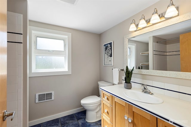 bathroom featuring tile patterned floors, vanity, and toilet