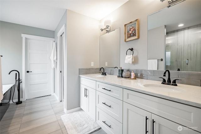 bathroom with tile patterned floors, vanity, and an enclosed shower