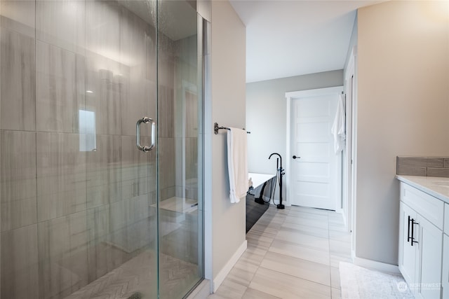 bathroom with tile patterned flooring, vanity, and separate shower and tub