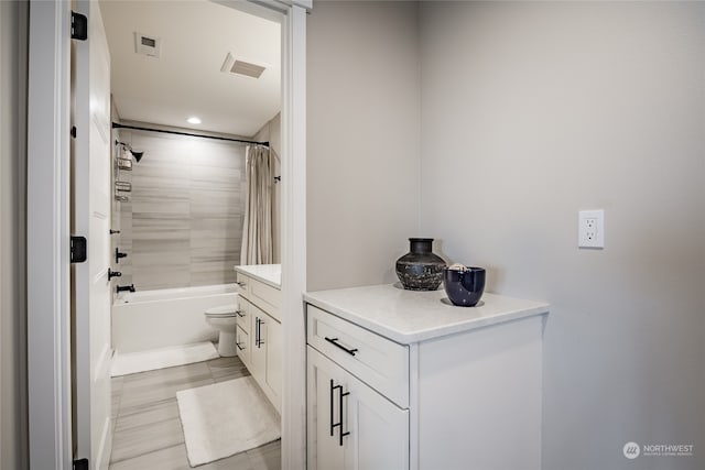 full bathroom with vanity, toilet, and shower / bath combo with shower curtain