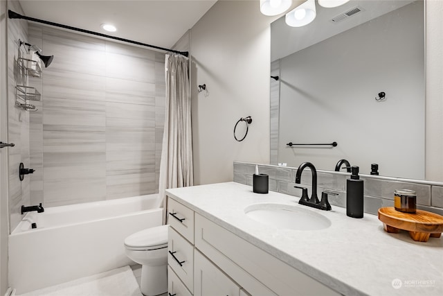 full bathroom featuring shower / tub combo, vanity, and toilet