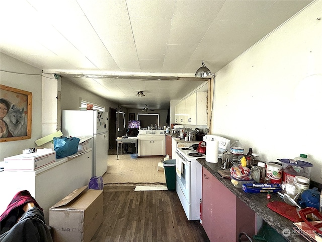 kitchen with ceiling fan, white appliances, and dark hardwood / wood-style flooring