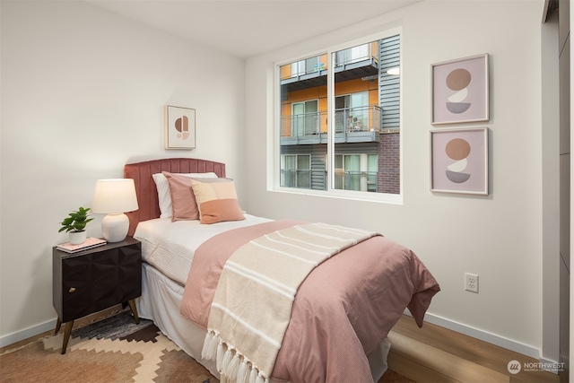 bedroom with wood-type flooring