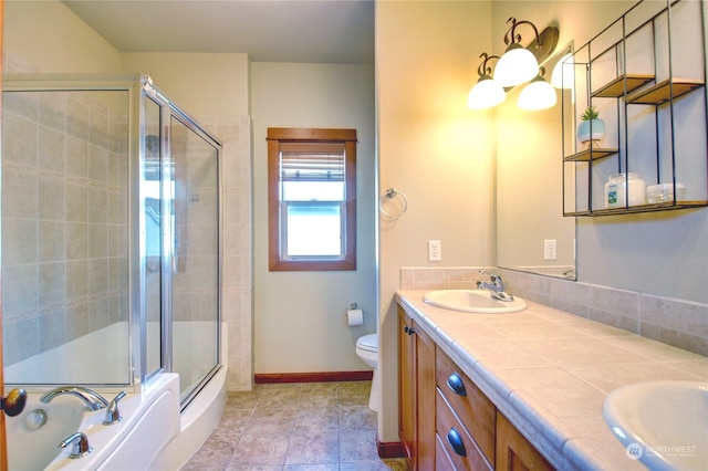 bathroom featuring toilet, walk in shower, vanity, and tile patterned floors