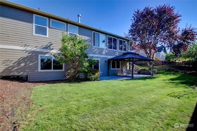 back of house with a gazebo, a patio area, and a yard