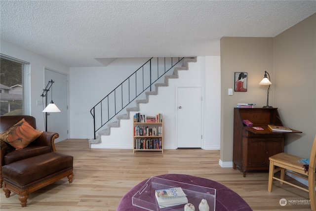 living room with hardwood / wood-style flooring and a textured ceiling