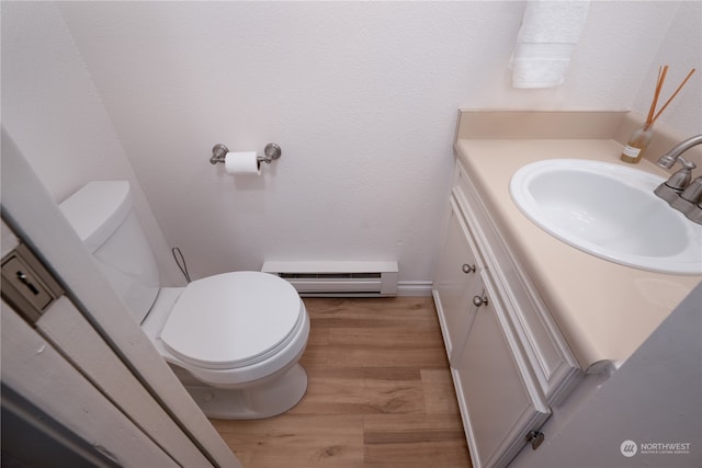 bathroom featuring vanity, baseboard heating, toilet, and hardwood / wood-style flooring