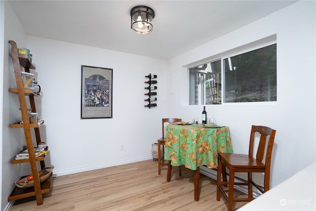 dining space with light hardwood / wood-style flooring