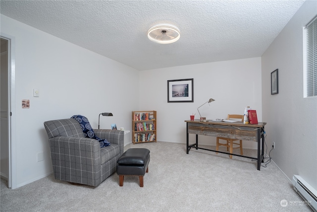 living area with baseboard heating, a textured ceiling, and light carpet