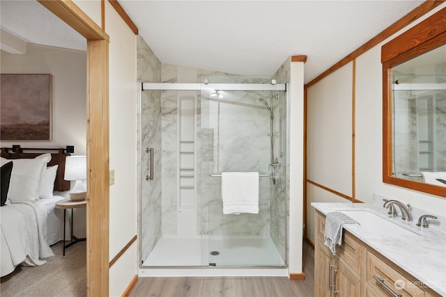 bathroom featuring vanity, an enclosed shower, hardwood / wood-style floors, and lofted ceiling