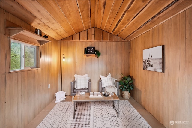 sitting room with wooden ceiling, vaulted ceiling, and wooden walls