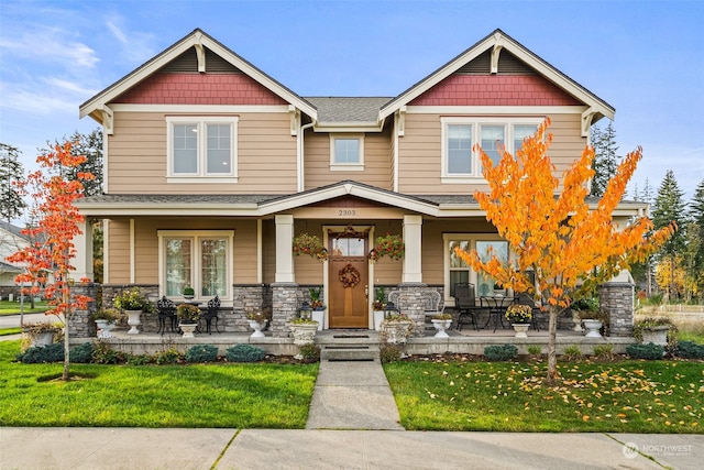 craftsman-style home featuring a front yard and a porch