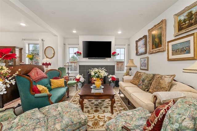 living room featuring a tile fireplace