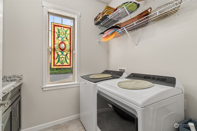 laundry room with cabinets and washing machine and clothes dryer