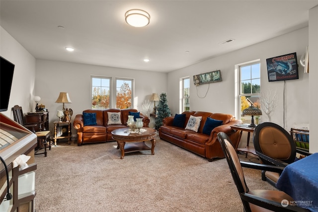 living room with a wealth of natural light and light colored carpet