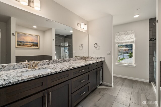 bathroom featuring an enclosed shower and vanity