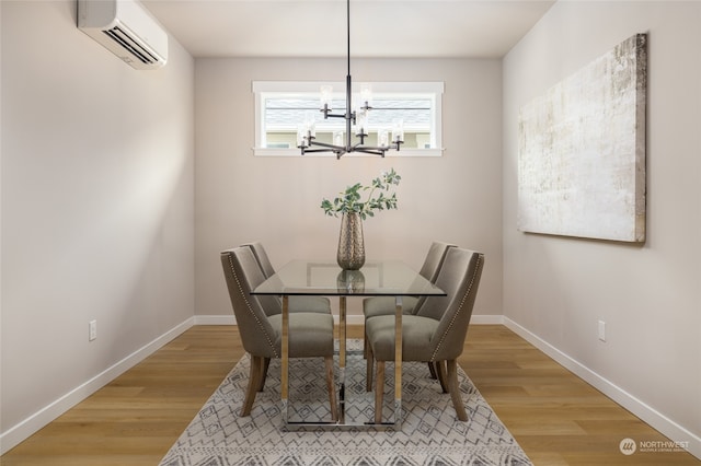 dining room with a wall unit AC, a chandelier, and hardwood / wood-style flooring