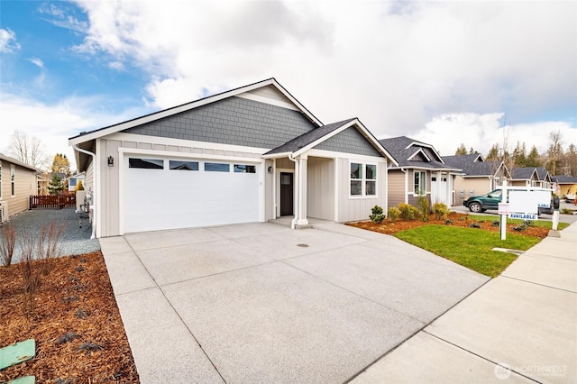 ranch-style home featuring driveway, an attached garage, fence, and board and batten siding