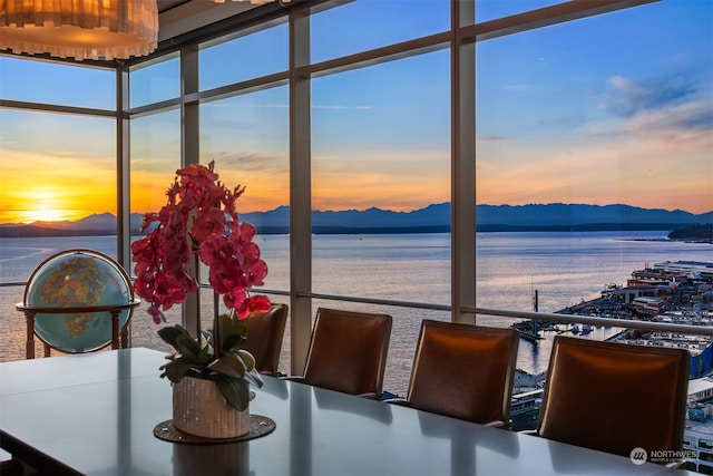 dining area with a water and mountain view