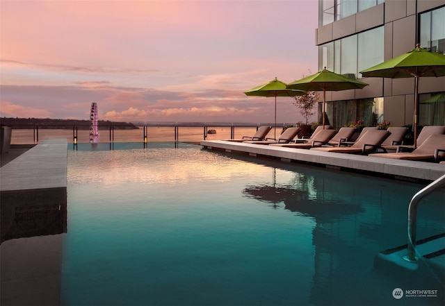 pool at dusk with a water view