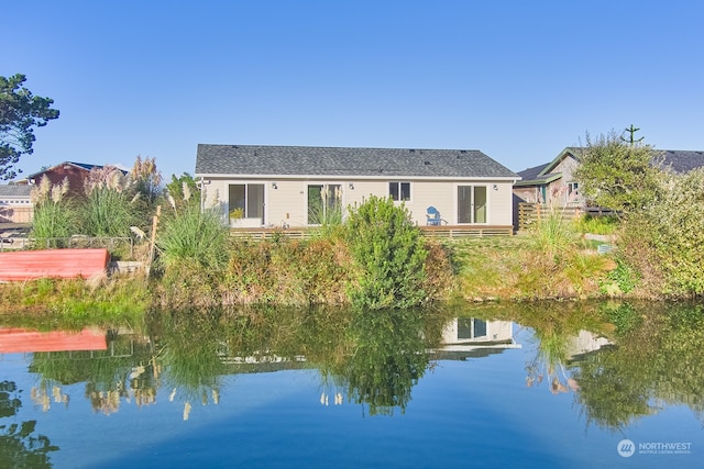 back of house featuring a water view