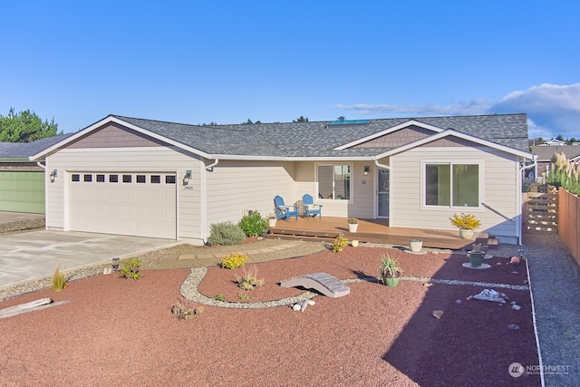 ranch-style home featuring a wooden deck and a garage