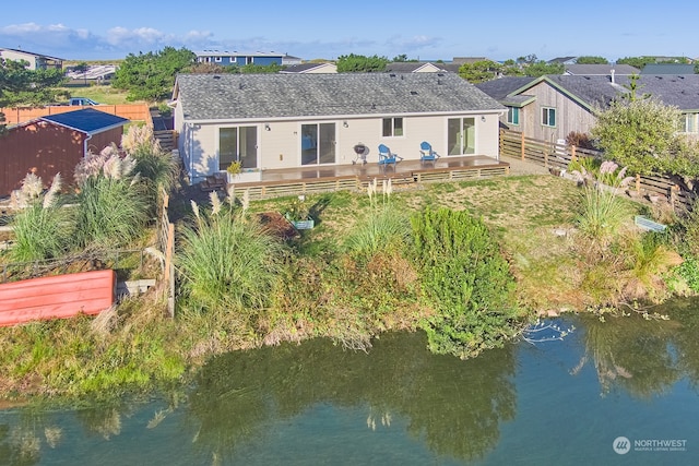 back of house featuring a deck with water view