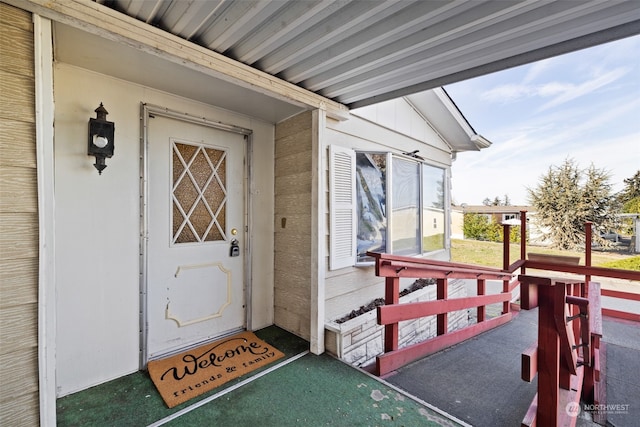 view of exterior entry with covered porch