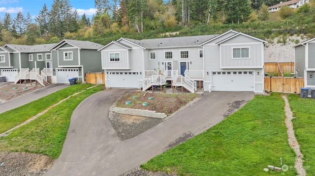 split foyer home featuring a garage and a front lawn