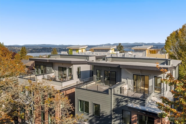 back of house with a balcony and a mountain view