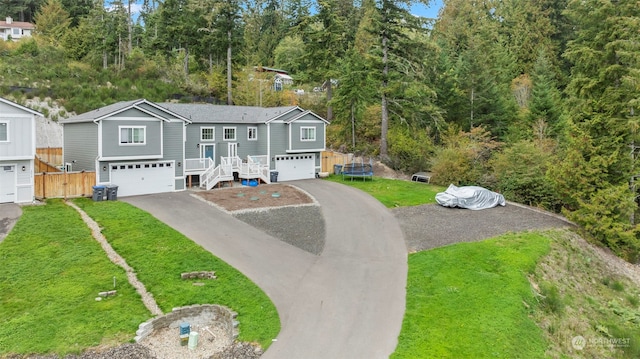 view of front of home with a front yard and a garage