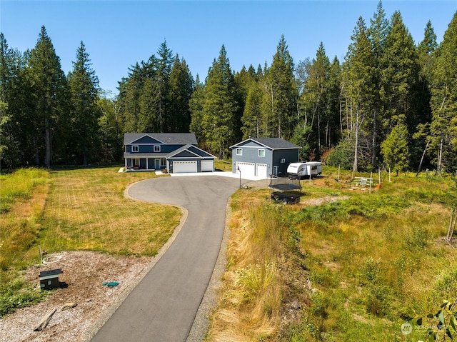 view of front of property featuring a front yard and a garage